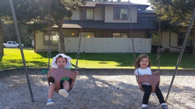 Aria and Lena on the swing